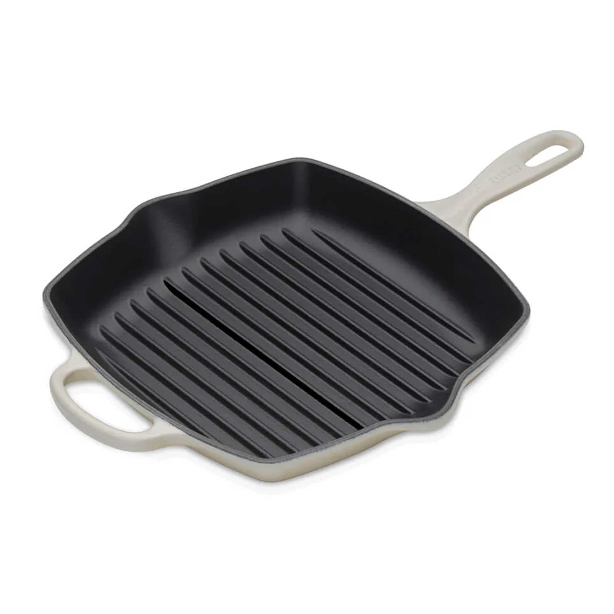 Black grill pan with beige handles on a white background