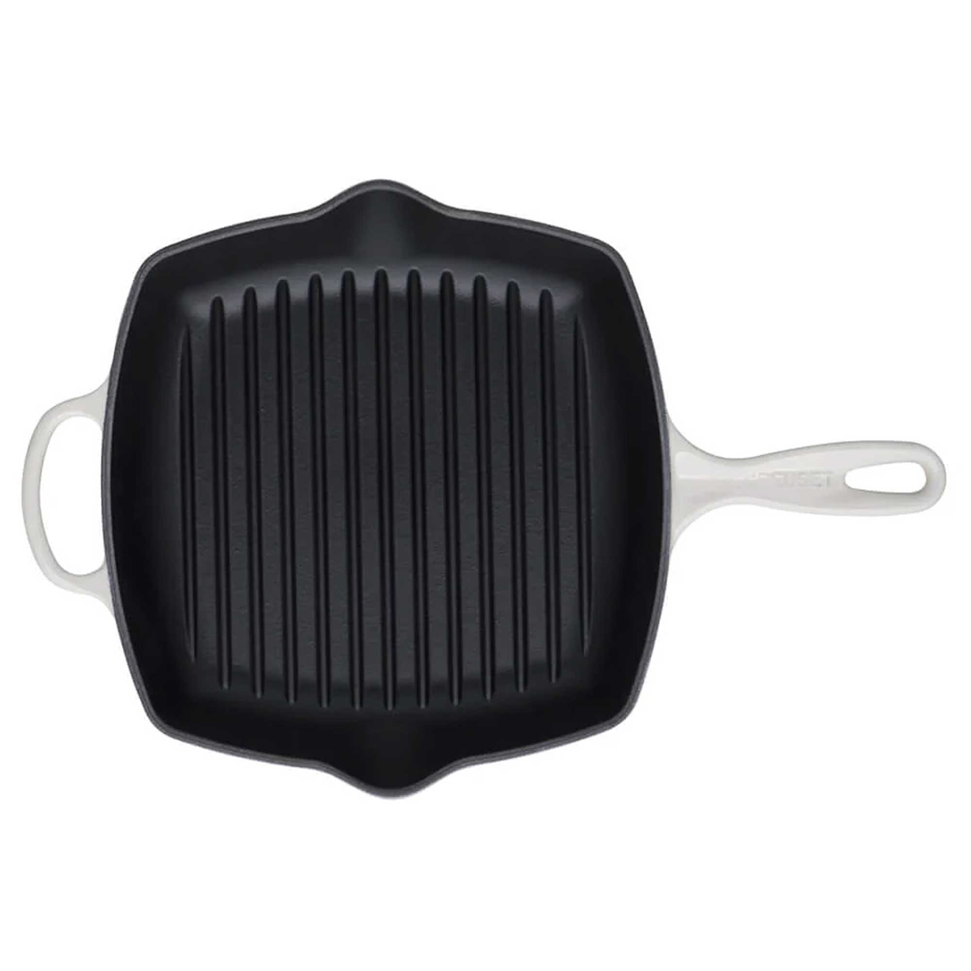 Black cast iron grill pan with white handles on a white background