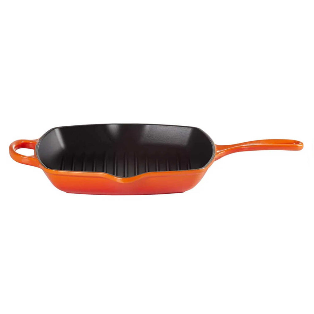 Orange cast iron grill pan on a white background