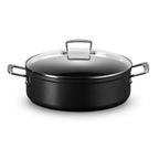 Black cookware pot with clear lid on a white background