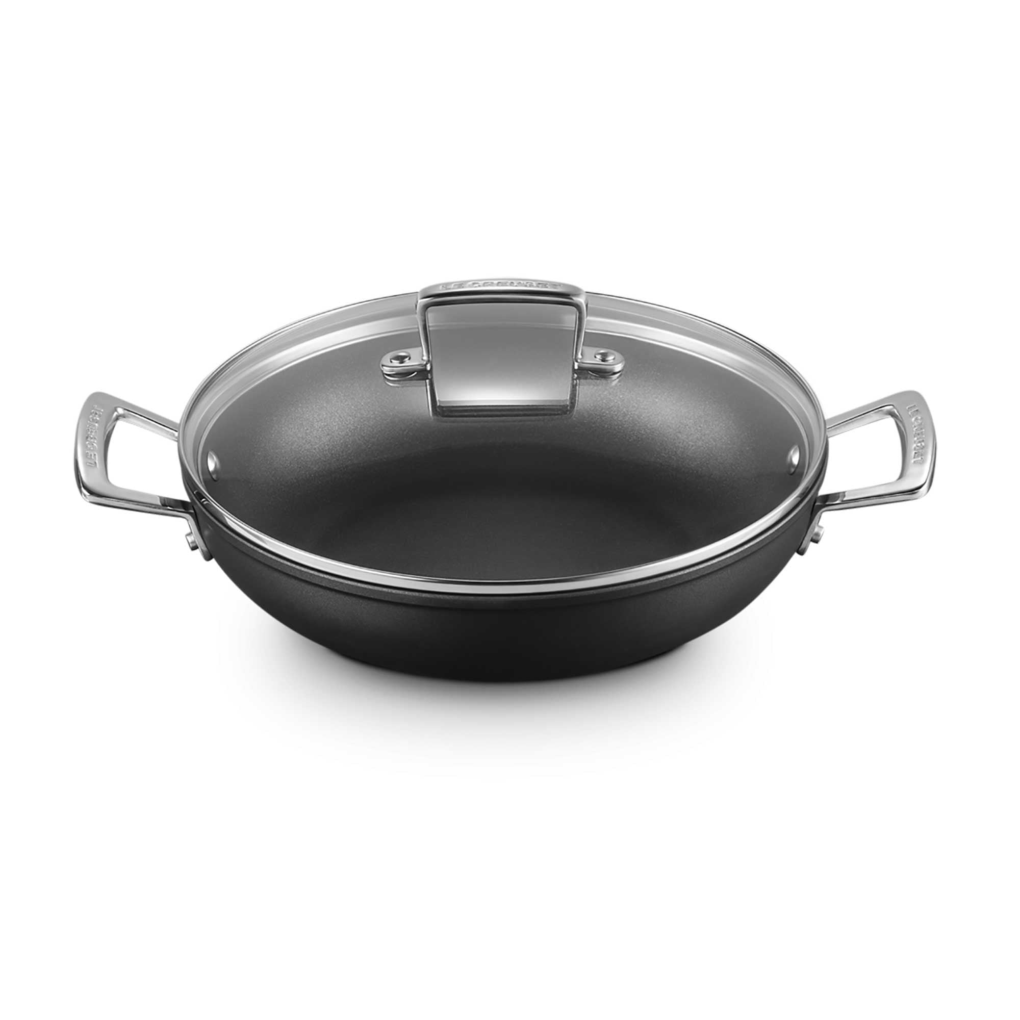 Shallow casserole with clear lid and silver handles on white background