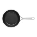 Black frying pan with a silver handle on a white background