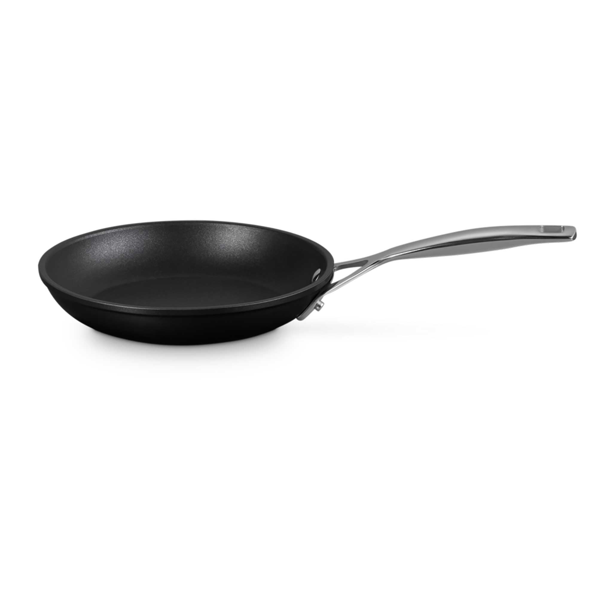 Black frying pan with a silver handle on a white background