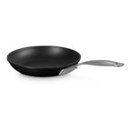 Black frying pan with a silver handle on a white background