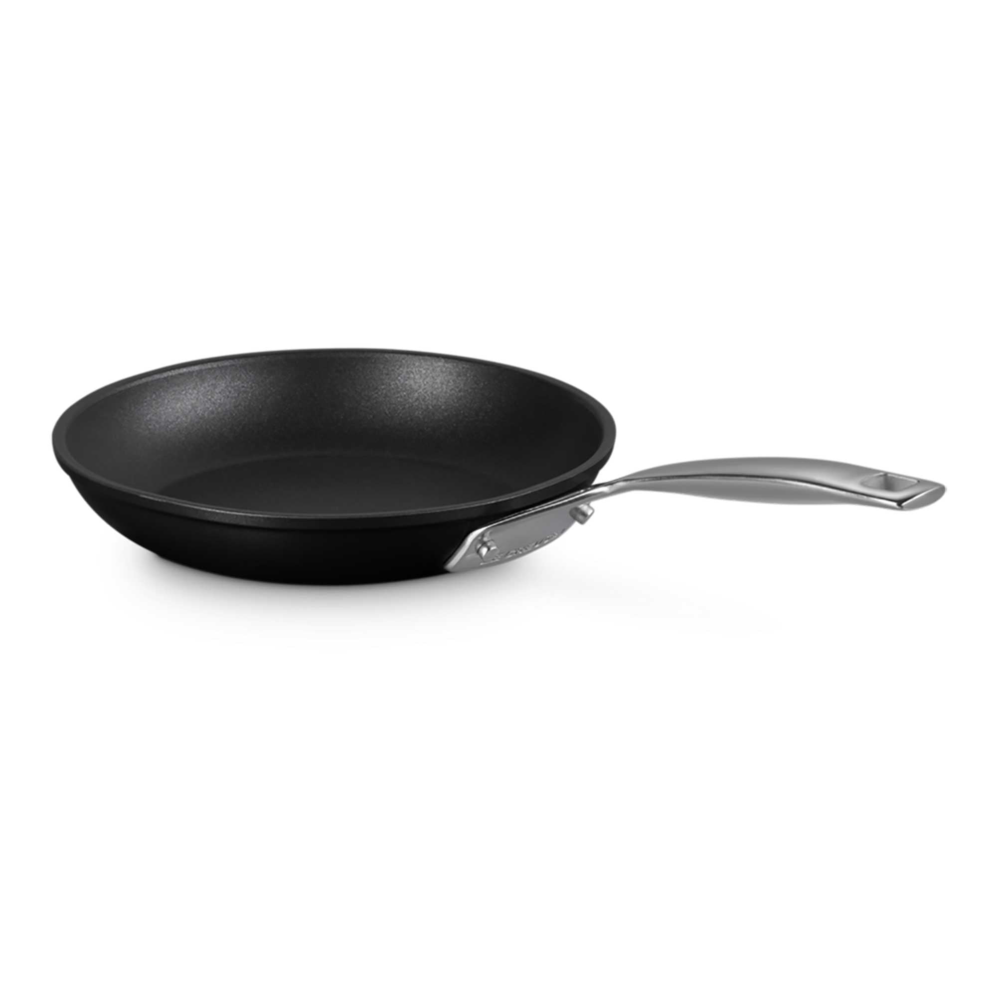 Black frying pan with a silver handle on a white background