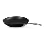 Black frying pan with a silver handle on a white background