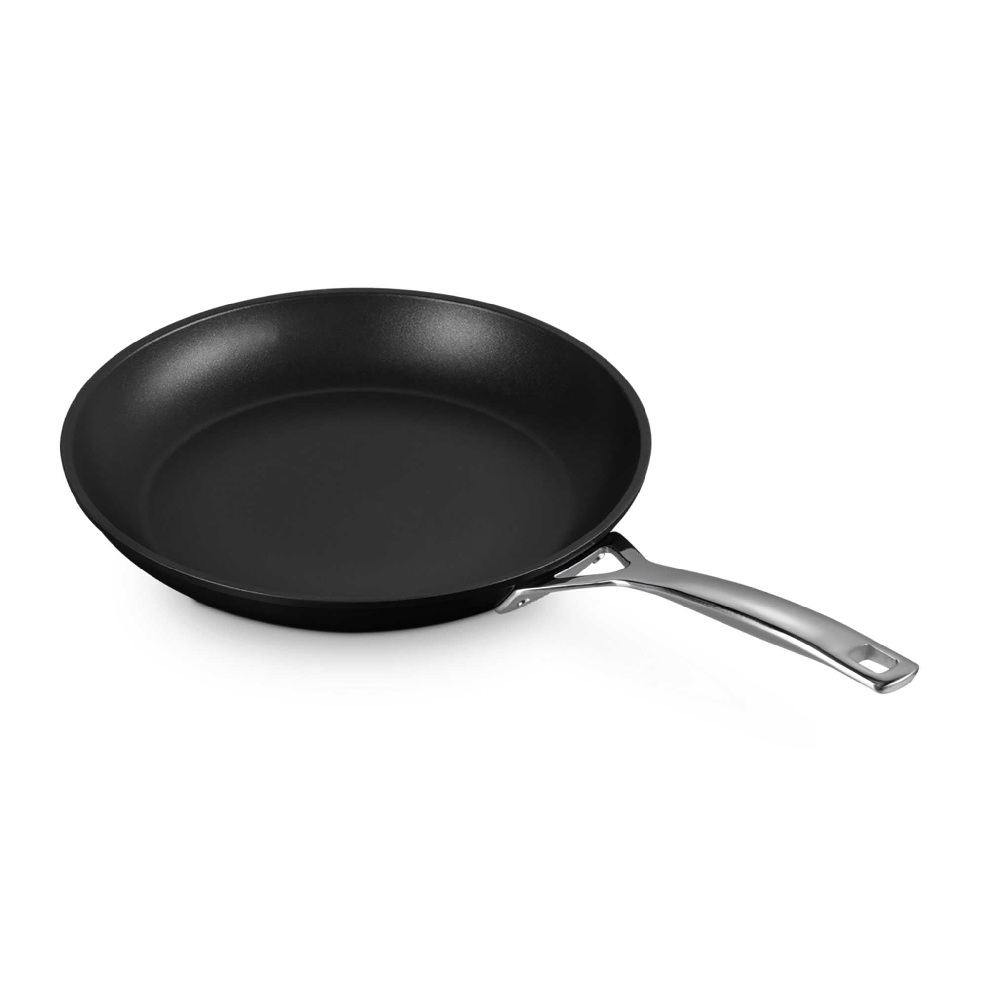 Black frying pan with a silver handle on a white background