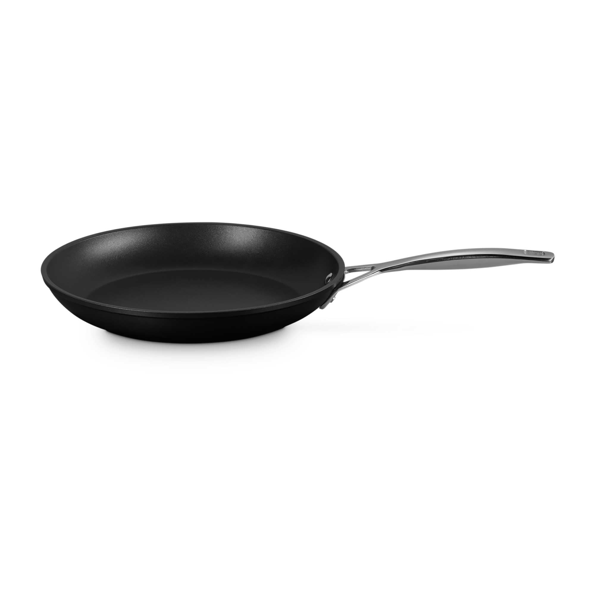 Black frying pan with a silver handle on a white background