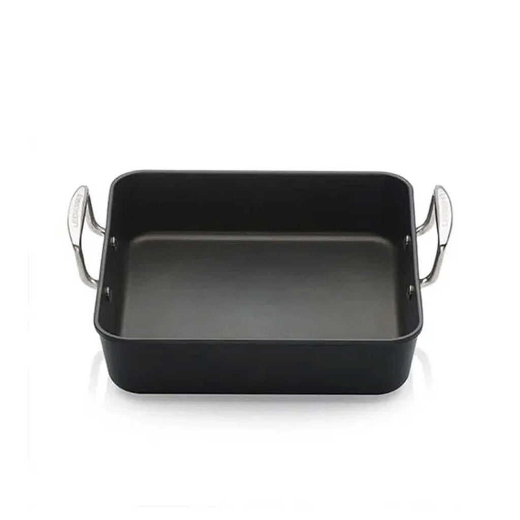 Black square roasting pan with silver handles on a white background