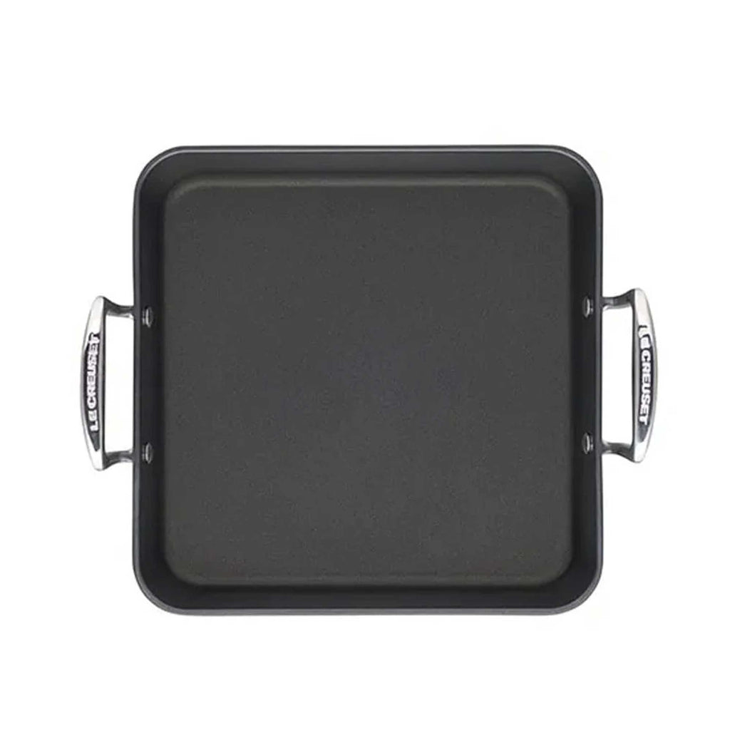 Black square roasting pan with handles on a white background