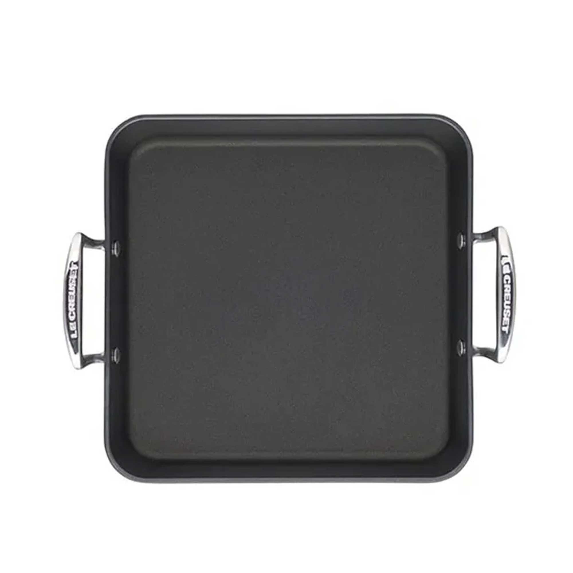 Black square roasting pan with handles on a white background