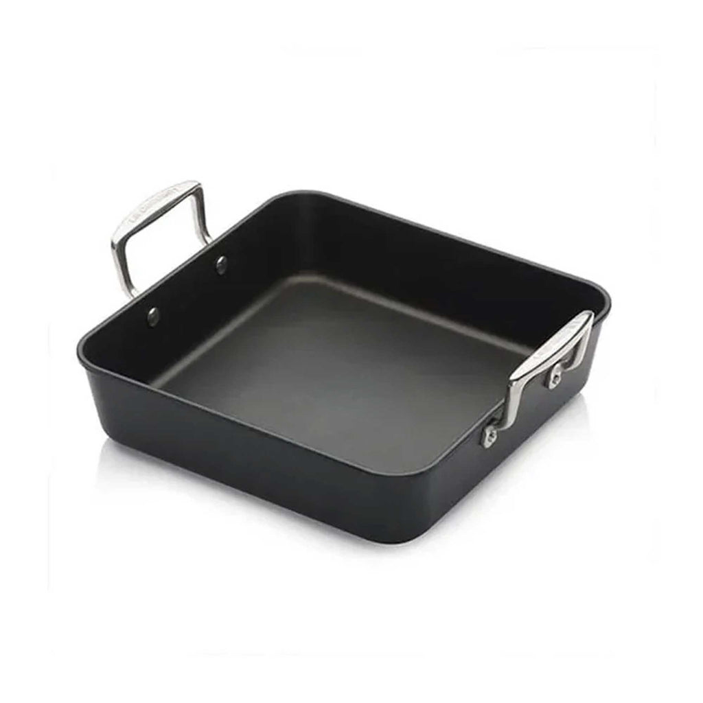 Black square roasting pan with silver handles on a white background