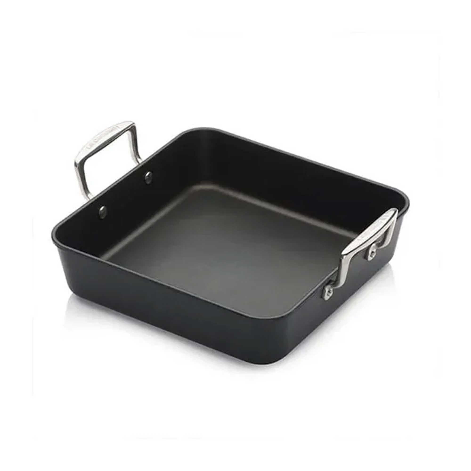 Black square roasting pan with silver handles on a white background