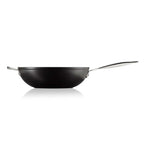 Black stir fry pan with a silver handle on a white background