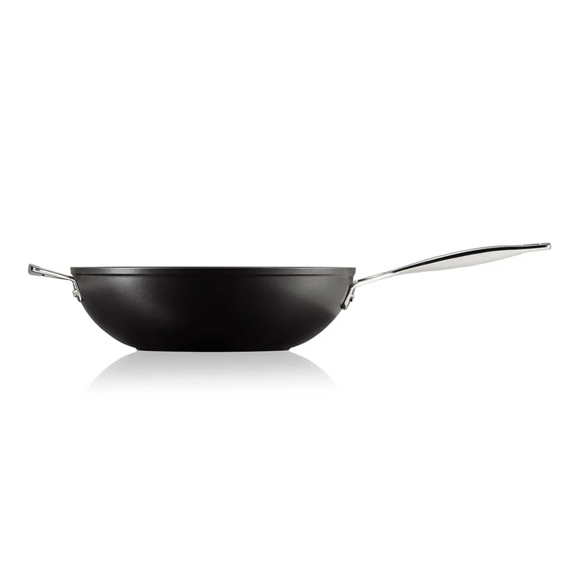 Black stir fry pan with a silver handle on a white background