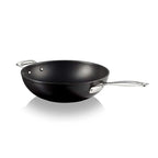 Black stir fry pan with a silver handle on a white background