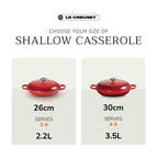 Le Creuset shallow casserole with size and serving capacity information on a white background.