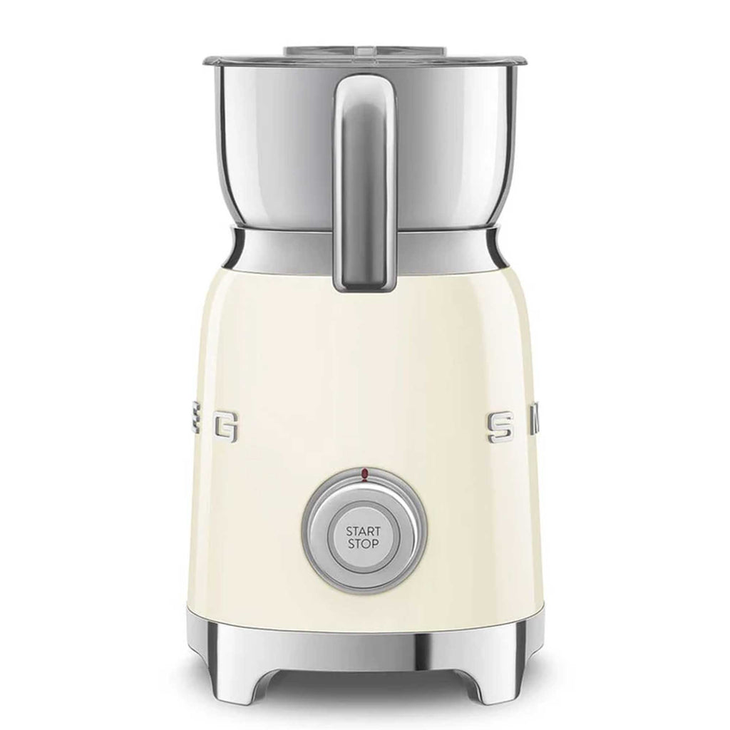 Cream-colored milk frother with metallic top on a white background
