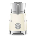 Cream-colored milk frother with metallic top on a white background