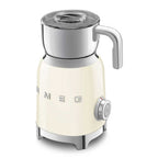 Cream-colored milk frother with silver accents on a white background