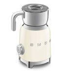 Cream-colored milk frother with chrome accents on a white background