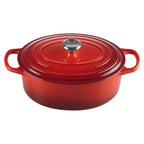 Cerise cast ironoval casserole with lid on a white background