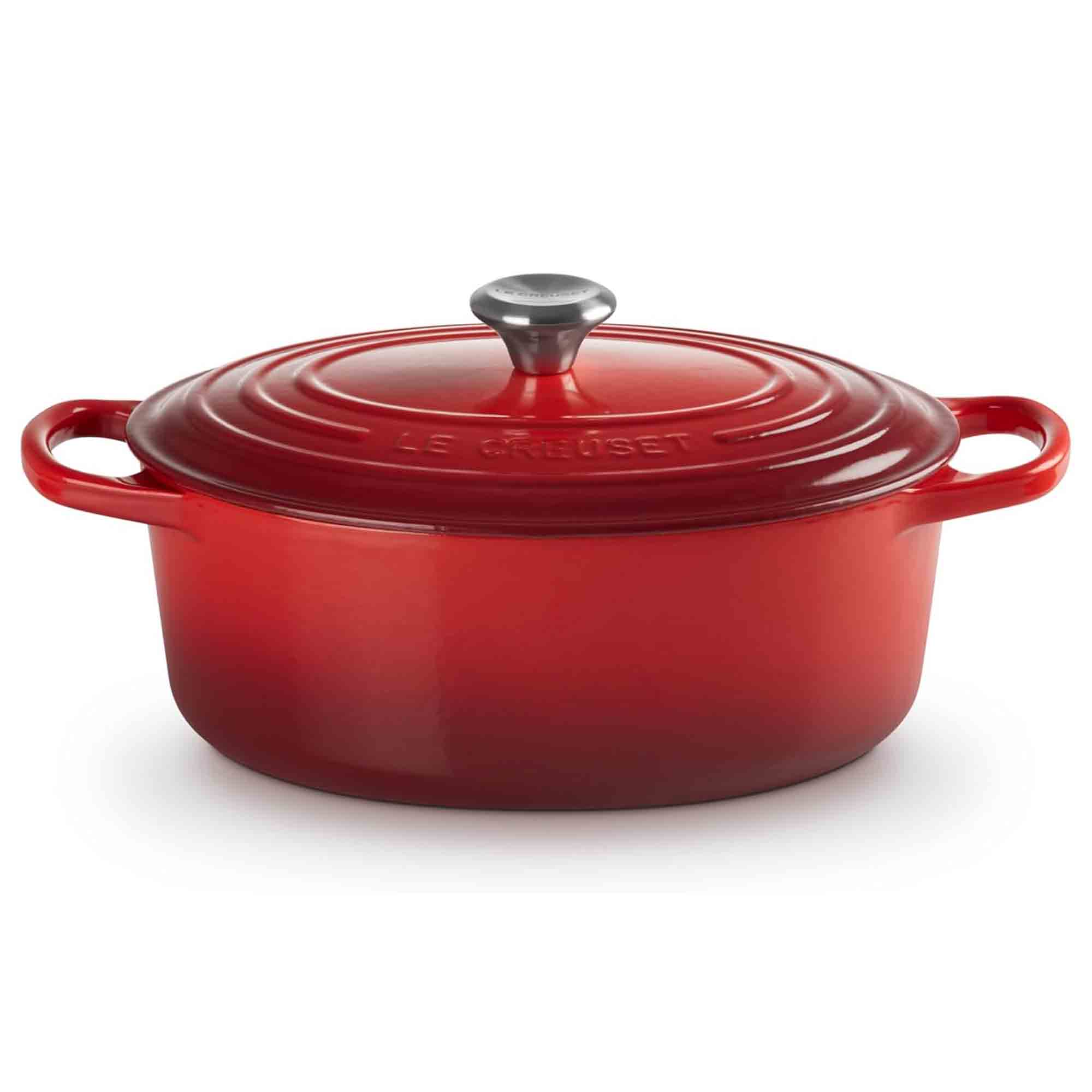 Cerise cast iron oval casssserole with a lid on a white background