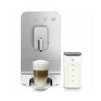 SMEG coffee machine with a cup of coffee and milk pitcher on a white background