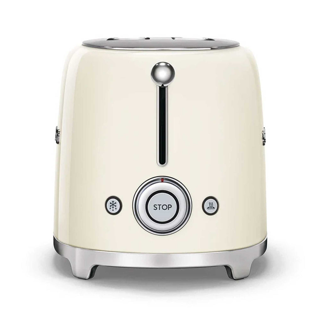 Cream-colored toaster with silver accents on a white background