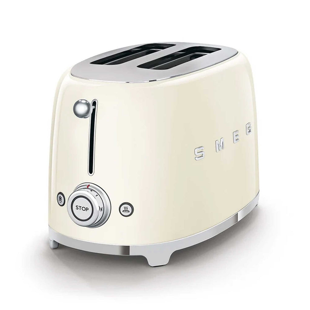 Cream-colored toaster with metallic accents on a white background