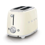 Cream-colored toaster with metallic accents on a white background