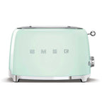 Pastel green toaster with 'SMEG' branding on a white background