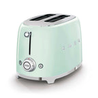 Pastel green toaster on white background