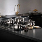 Silver saucepan set on a grey worktop