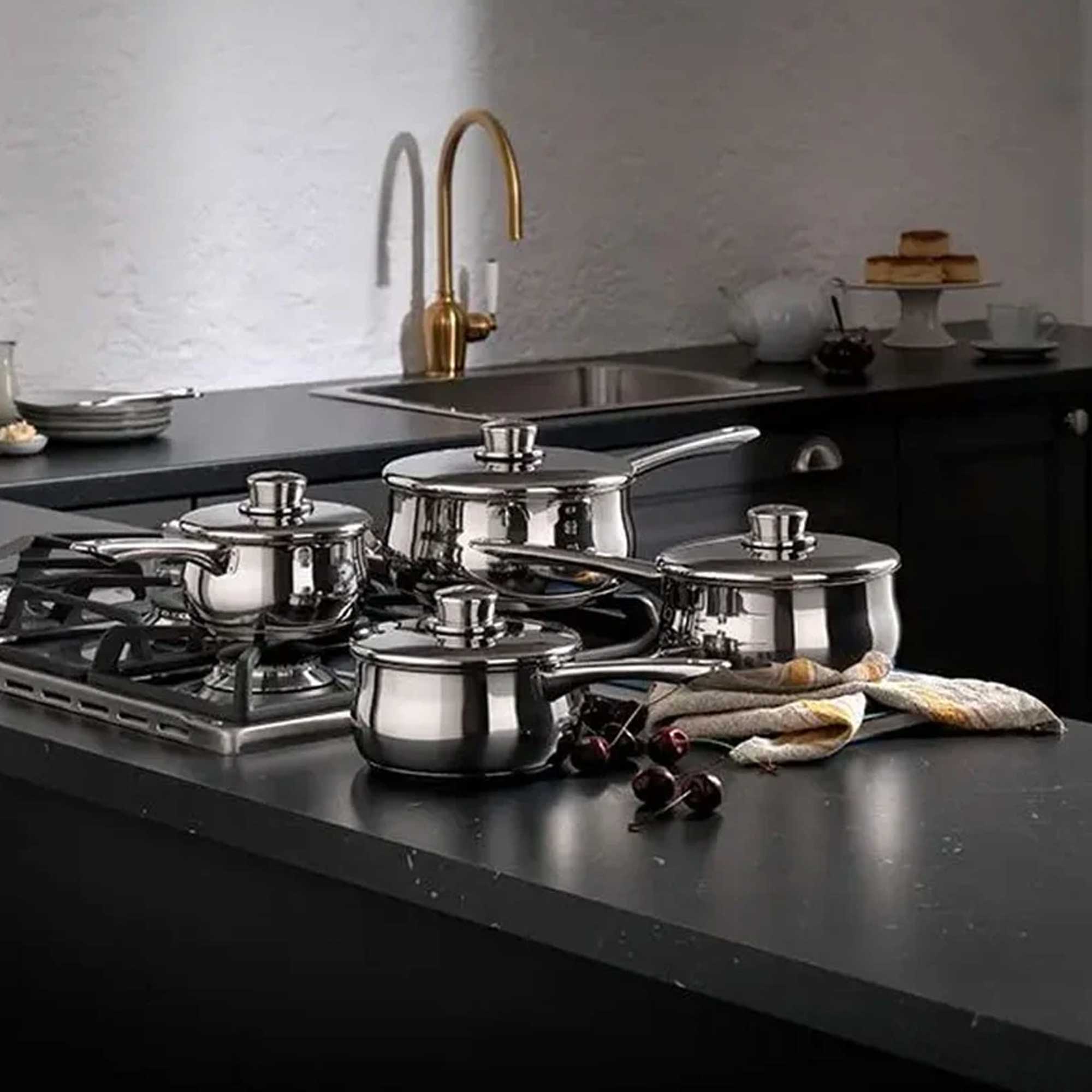 Silver saucepan set on a grey worktop