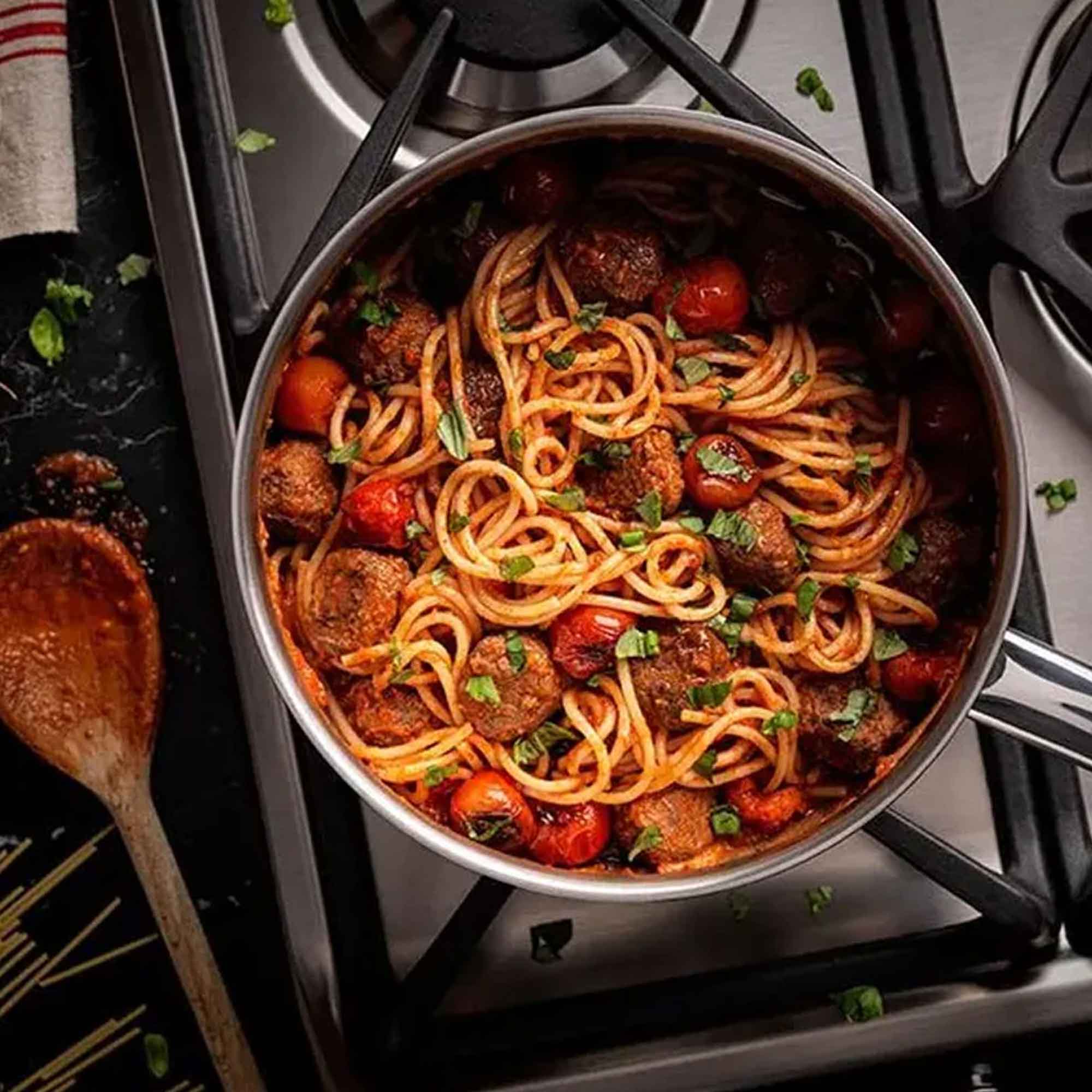 Silver saucepan with spaghetti tomatoes and meatballs