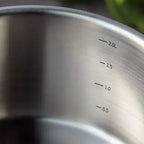 Close-up of a saucepan with volume markings on a blurred background