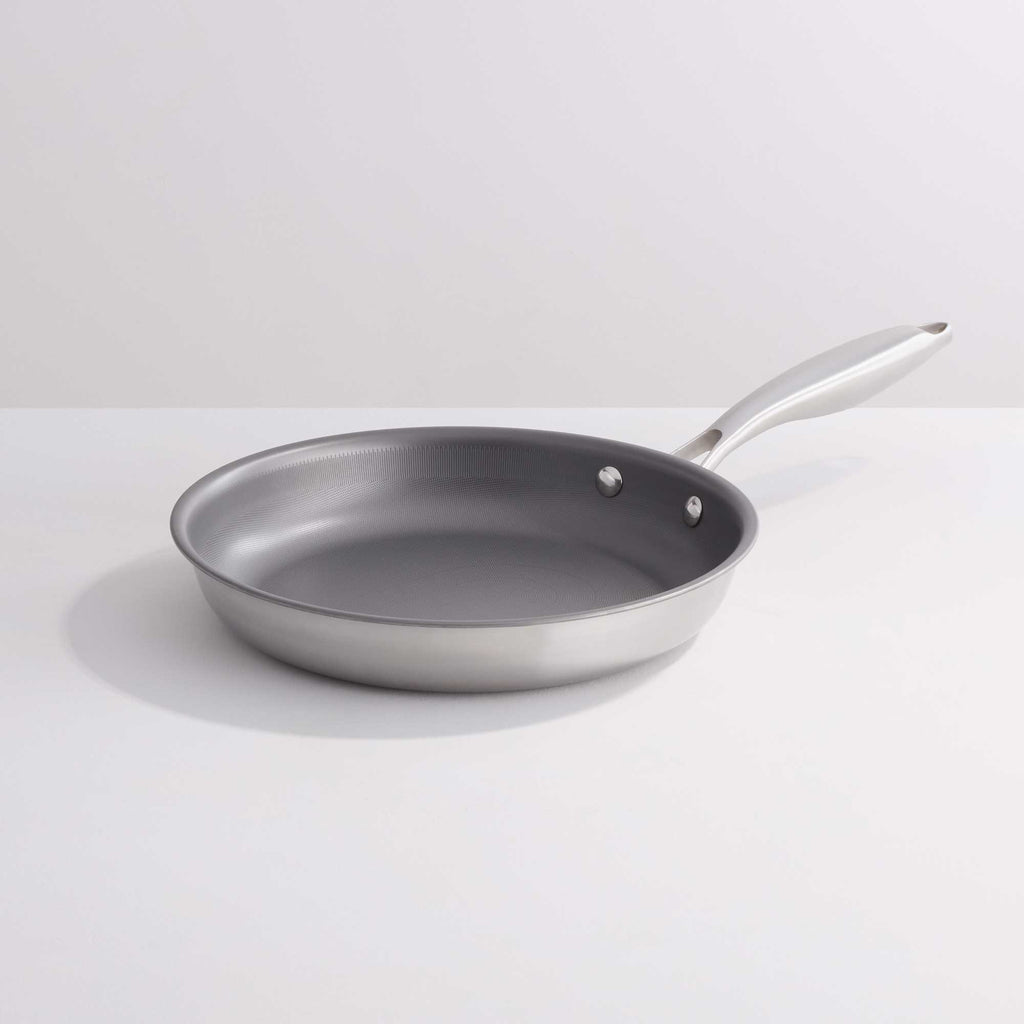 A stainless steel frying pan with a dark gray non-stick interior and a silver handle, shown on a clean white background.