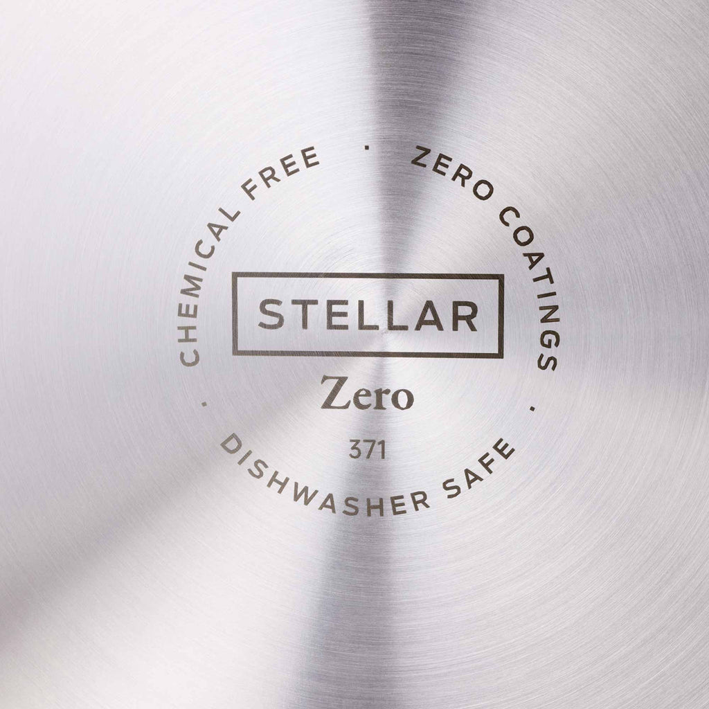 Close-up of a brushed metallic surface with a circular printed label reading 'STELLAR Zero 371' and surrounding text 'CHEMICAL FREE', 'ZERO COATINGS', and 'DISHWASHER SAFE'.