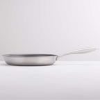 A stainless steel frying pan with a long, curved white handle, photographed on a clean white studio background.