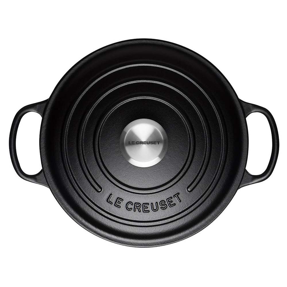 Satin Black Le Creuset casserole lid on a white background