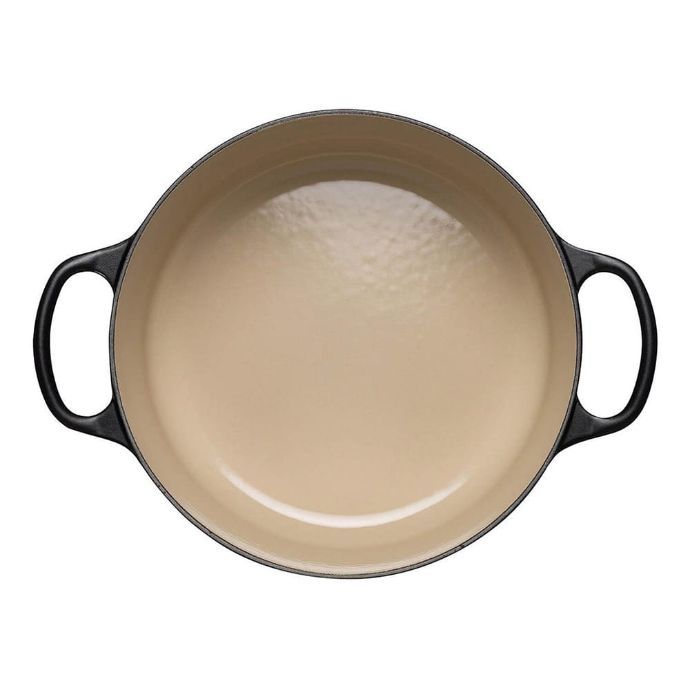 Satin Black cast iron casserole with beige interior on a white background