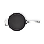 Black frying pan with a silver handle on a white background