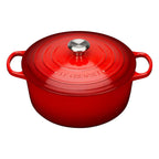 Cerise Le Creuset cast iron casserole on a white background