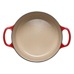 Cerise cast iron casserole on a white background