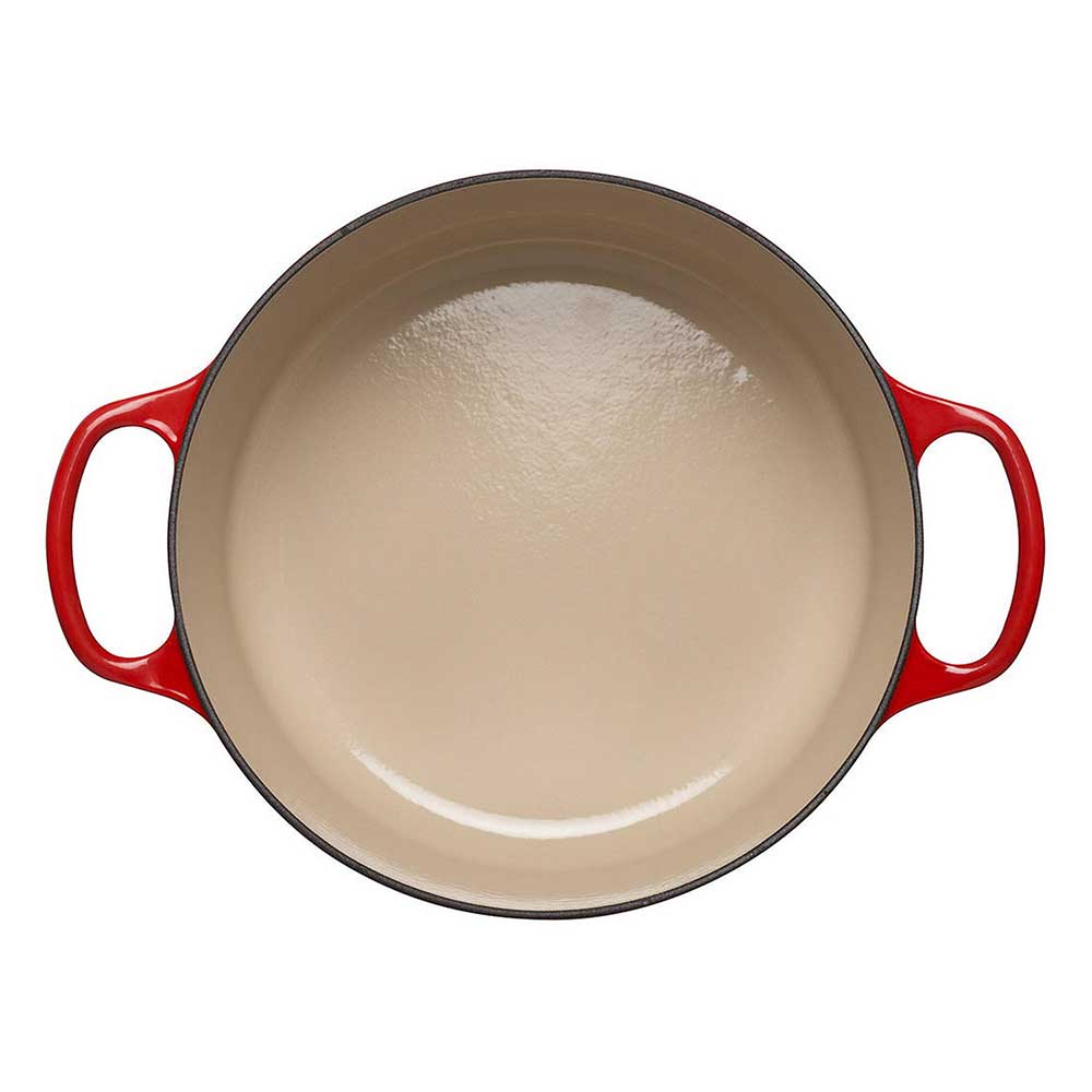Cerise cast iron casserole on a white background