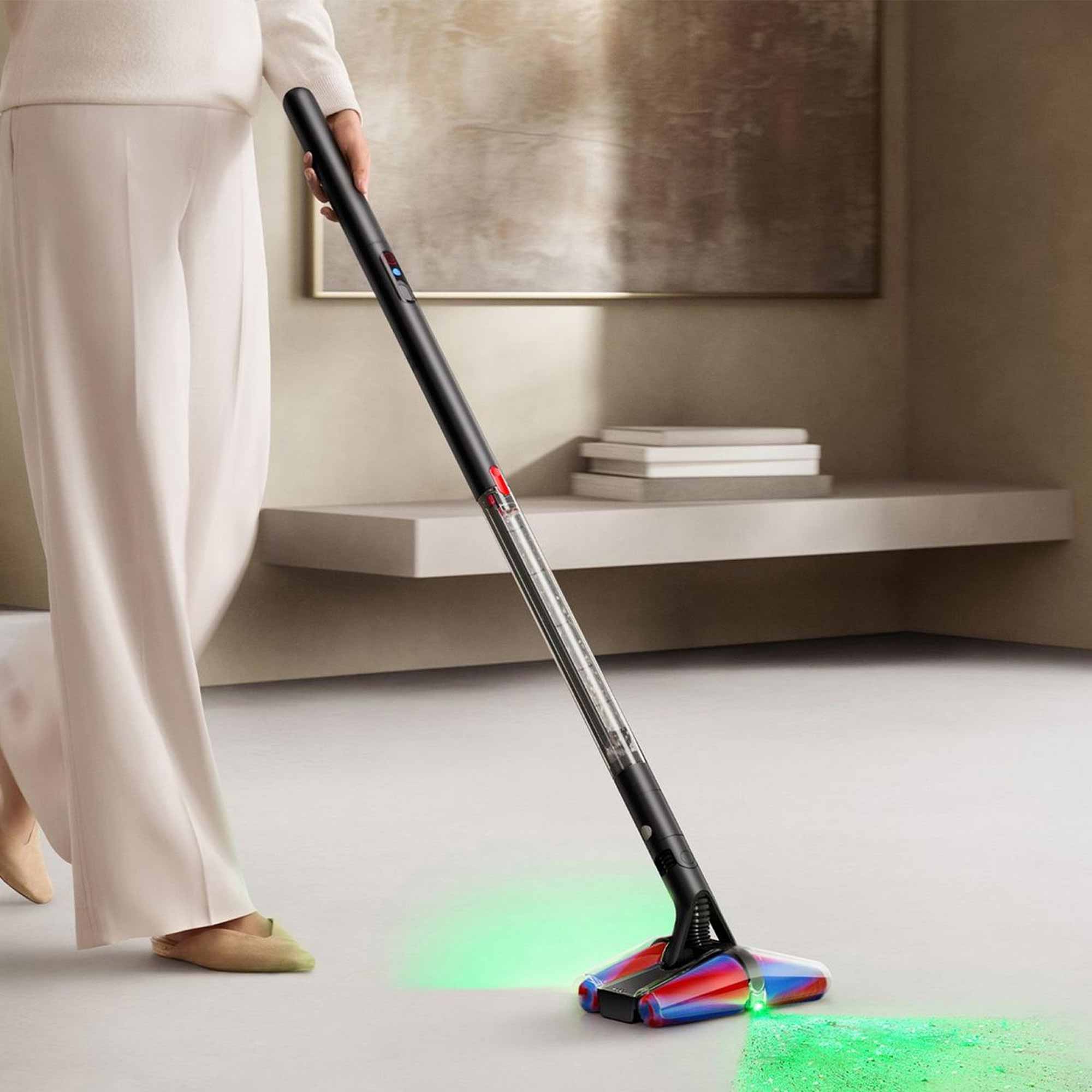 Someone pushing the Dyson PencilVac on a floor, highlighting dust.